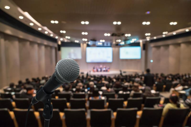 Microphone with blurred conference hall in the background