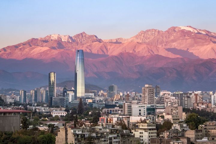 Aerial view of Santiago skyline at sunset with Costanera skyscraper and Andes Mountains